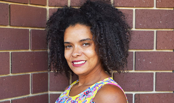 African American woman in yellow shirt smiling