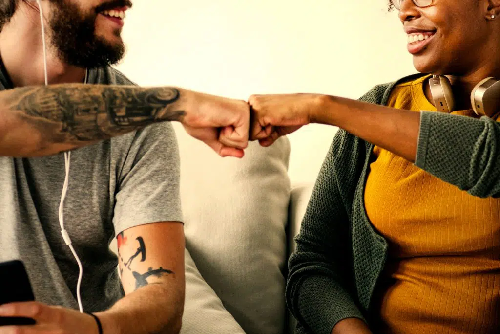 two people giving fist bumps