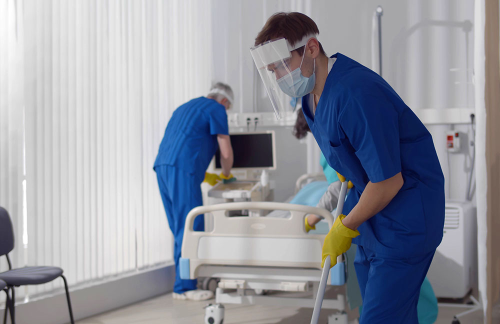 image of two custodians cleaning hospital room