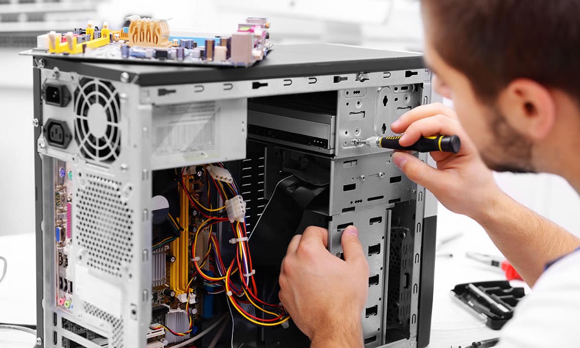 worker taking apart a computer