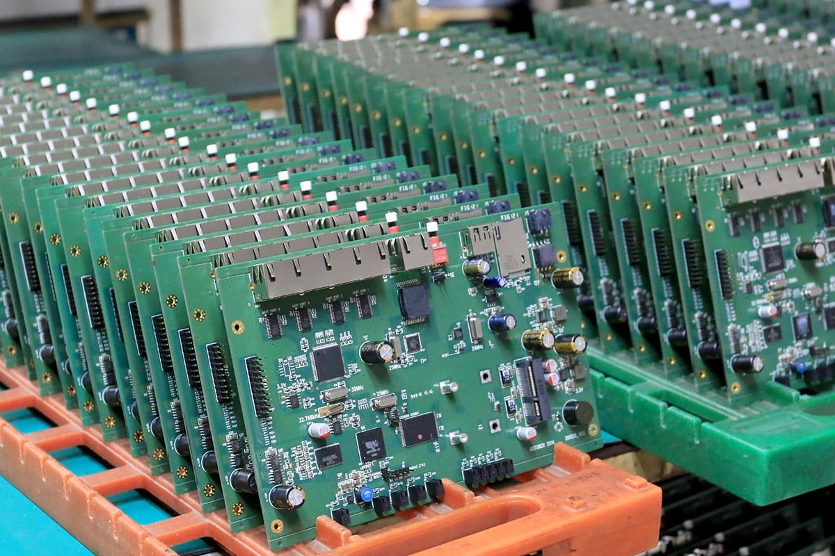 Three trays of assembled printed circuit boards
