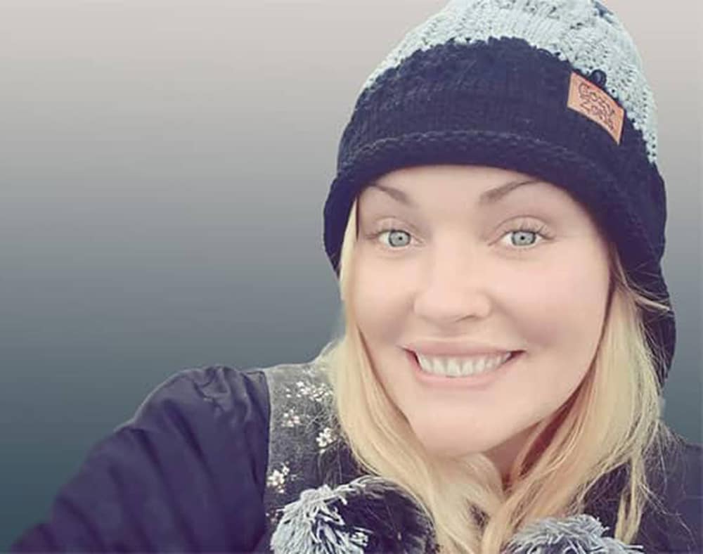 Caucasian woman wearing beanie smiling