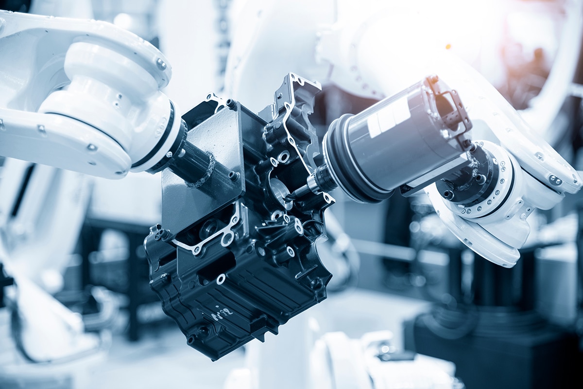 A closeup of a cobot working on a device assembly.