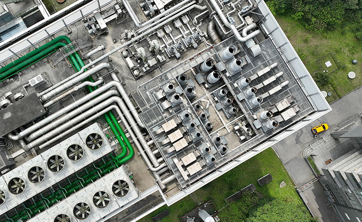An overhead, exterior shot of a commercial building, showing a large HVAC system whose components cover the roof